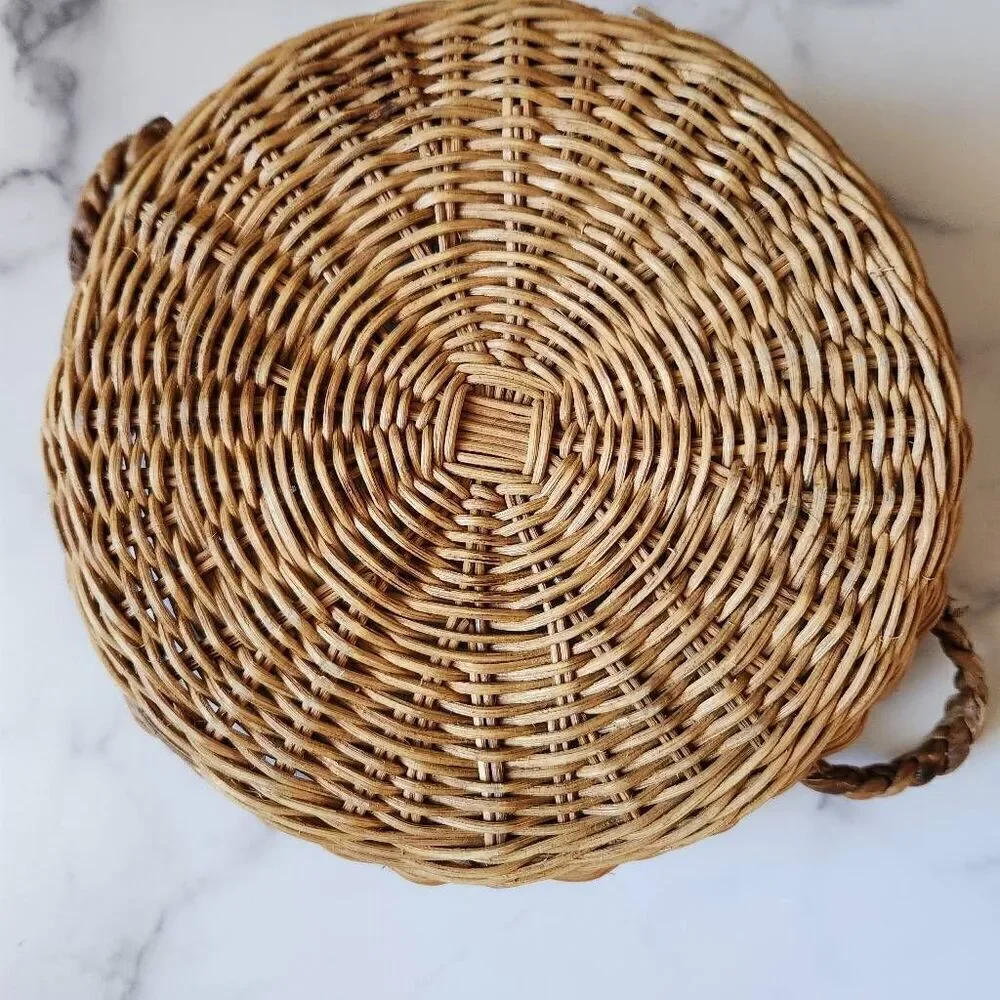 Woven wicker round basket handles various clear glass bottles vintage spice pine